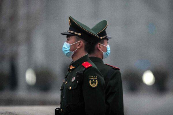 Chinese soldiers stand guard near Tiananmen Square in Beijing on March 5, 2021. (Nicolas Asfouri/AFP via Getty Images)