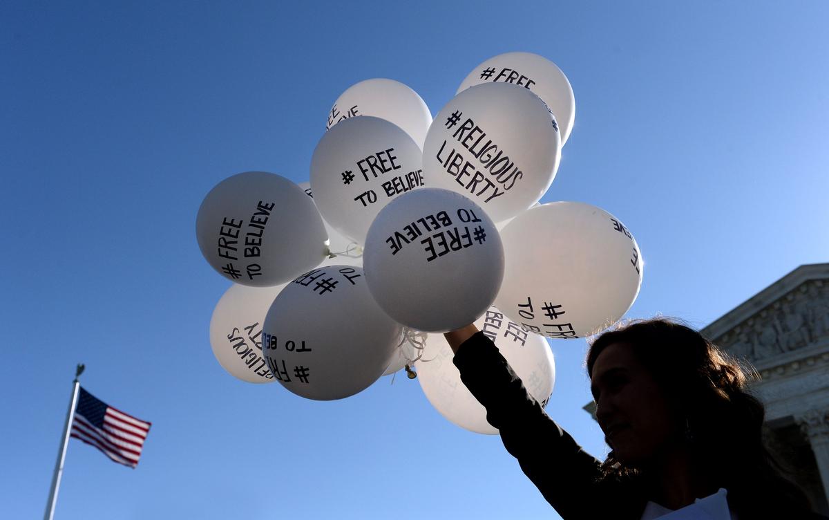 A protester holds balloons calling for religious freedom outside the U.S. Supreme Court in Washington on April 28, 2015. (Olivier Douliery/Getty Images)