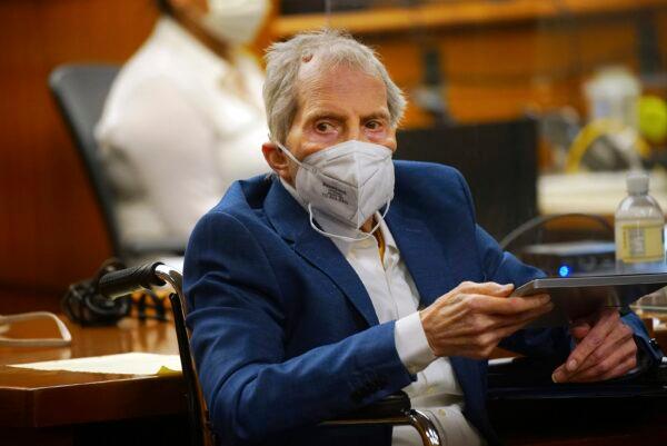 Robert Durst holds a device to read the real time spoken script as he appears in the courtroom of Judge Mark E. Windham as attorney's begin opening statements in the trial of the real estate scion charged with murder of longtime friend Susan Berman, at Los Angeles County Superior Court in Inglewood, Calif., on May 18, 2021. (Al Seib/Los Angeles Times via AP, Pool)