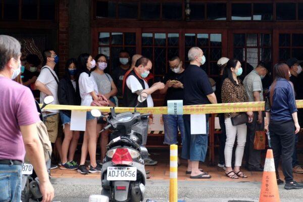 Local residents queue up for the COVID-19 virus testing at the Wanhua District in Taipei, Taiwan, on May 19, 2021. (SAM YEH/AFP via Getty Images)