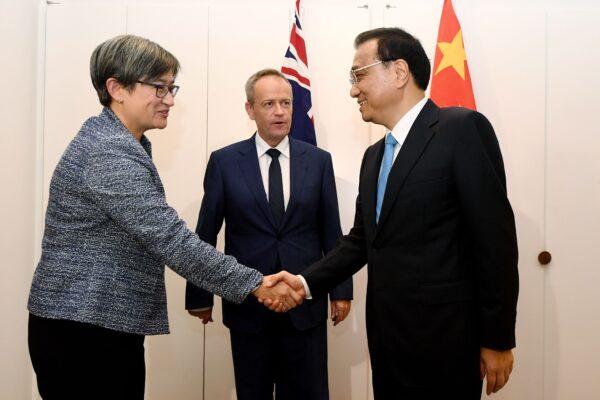 China's Premier Li Keqiang (R) shakes hands with Australia's shadow Foreign Minister Penny Wong (L), as Australia's Opposition Leader Bill Shorten looks on, at Government House in Canberra, Australia, on March 23, 2017. Premier Li Keqiang began a trade-focused visit touting communist China's fears of a U.S. slide towards protectionism. (LUKAS COCH/AFP via Getty Images)