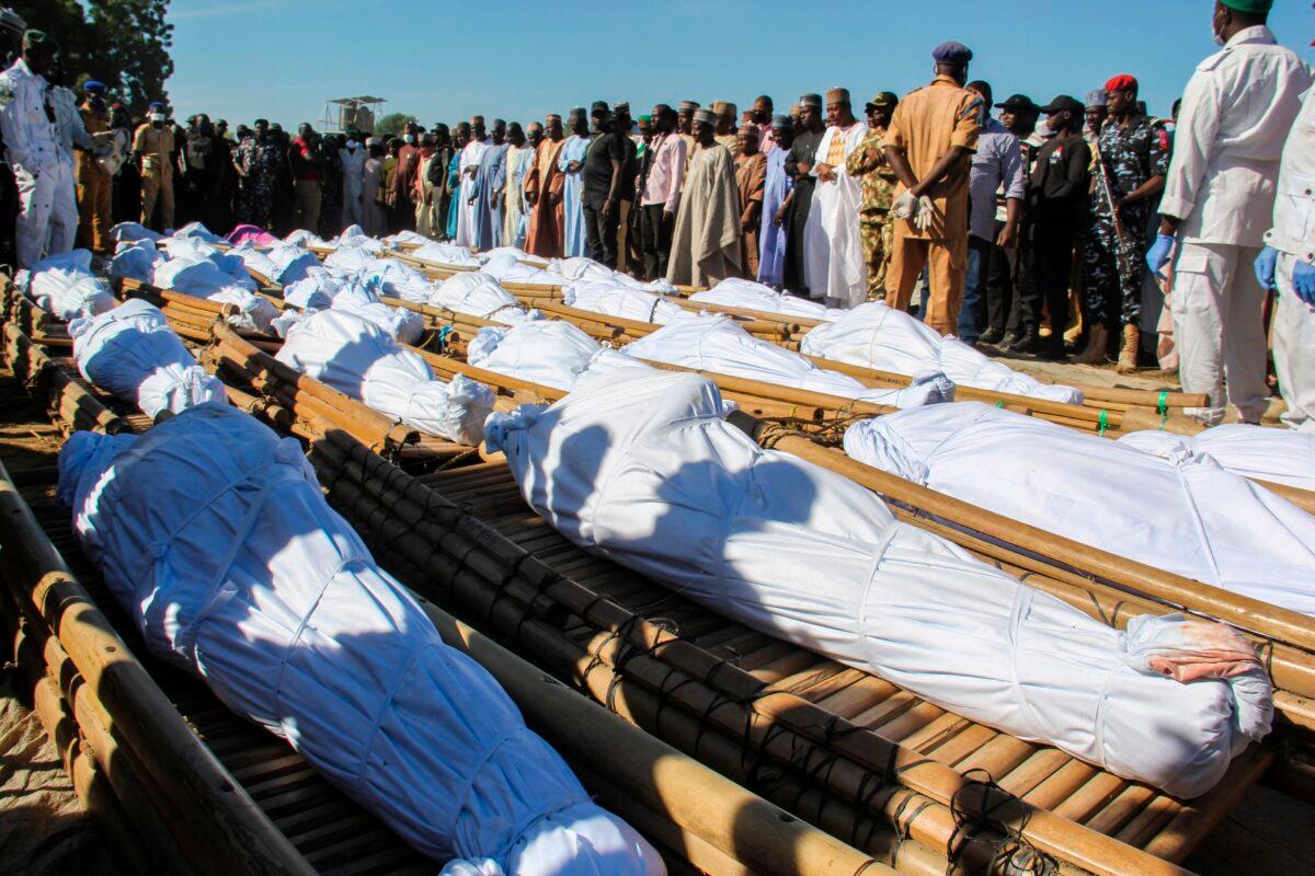Mourners attend the funeral of 43 farm workers in Zabarmari, about 12 miles from Maiduguri, Nigeria, on Nov. 29, 2020. The workers were killed by Boko Haram fighters who tied them up and slit their throats in rice fields near the village of Koshobe on Nov. 28, 2020. (Audu Marte/AFP via Getty Images)