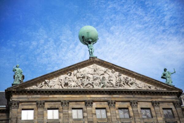 An 18-foot-tall statue of Atlas stands on the rooftop and in the main hall, carrying the universe on his shoulders. Atlas symbolizes the universe and the important position Amsterdam held during the Golden Age. (Jane Rix/Shutterstock)