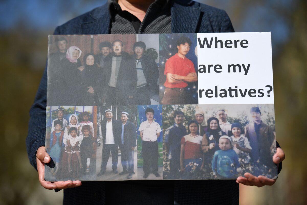 A member of the Uyghur community holds a placard as he joins a demonstration to call on the British Parliament to vote to recognize the alleged persecution of China's minority Uyghur people as genocide and crimes against humanity, in London on April 22, 2021. (Justin Tallis/AFP via Getty Images)