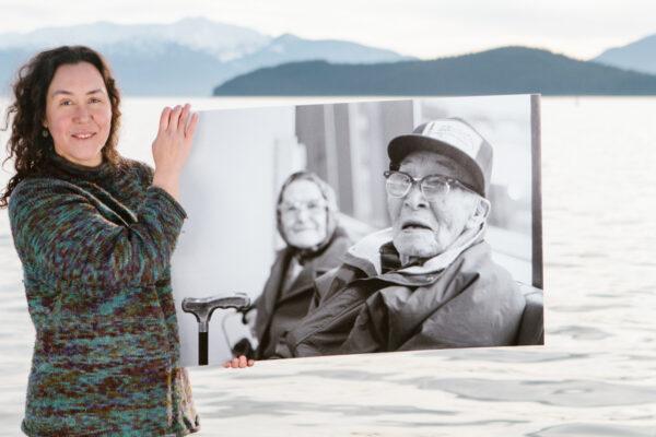 Melanie Brown, a Bristol Bay fisherman of Yupik/Inupiaq ancestry, with a photograph of her great-grandmother and great-grandfather. (Misha Dumov, <a href="https://www.mihaelblikshteyn.com/">MB Commercial Photography</a>)