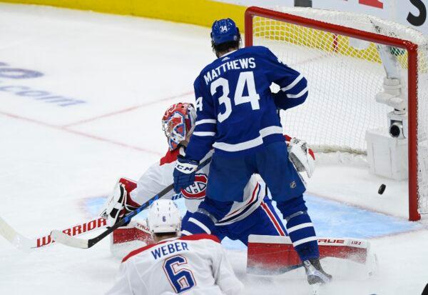 Toronto Maple Leafs forward Auston Matthews (34) scores past Montreal Canadiens goaltender Carey Price (31) during the second period of Game 2 of an NHL hockey Stanley Cup first-round playoff series, in Toronto, on May 22, 2021. (Nathan Denette/The Canadian Press via AP)