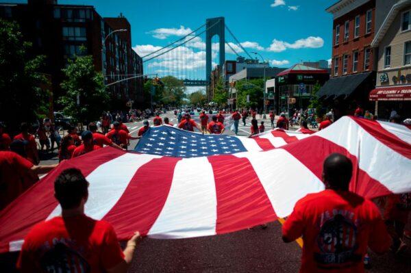 Veterans carry a huge American flag during the 152nd Memorial Day Parade in Brooklyn, N.Y., on May 27, 2019. (JOHANNES EISELE/AFP via Getty Images)
