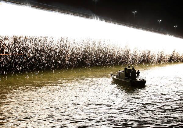 A Serbian police boat cruises on Sava river during Red Star fans celebrate after their team won the Serbian soccer league title in Belgrade, Serbia, on May 22, 2021. (Darko Vojinovic/AP Photo)