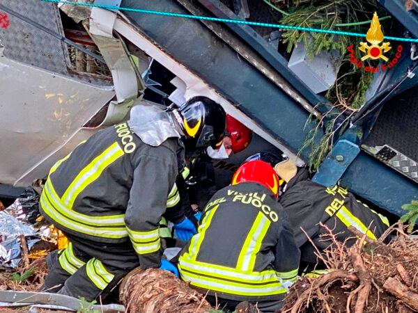Rescuers work by the wreckage of a cable car after it collapsed near the summit of the Stresa-Mottarone line in the Piedmont region, northern Italy, on May 23, 2021. (Italian Vigili del Fuoco Firefighters via AP)