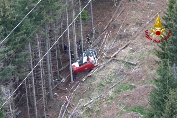 Rescuers work by the wreckage of a cable car after it collapsed near the summit of the Stresa-Mottarone line in the Piedmont region, northern Italy, as seen from the aerial photograph, on May 23, 2021. (Vigili del Fuoco Firefighters via AP)
