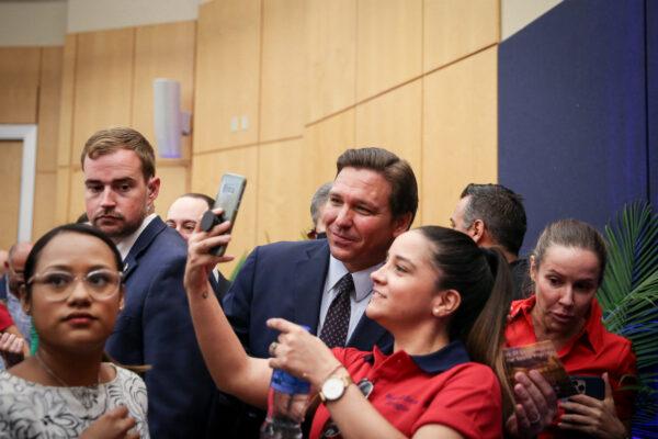 Florida Gov. Ron DeSantis mingles with audience after signing into law Senate Bill 7072 at Florida International University in Miami on May 24, 2021. (Samira Bouaou/The Epoch Times)