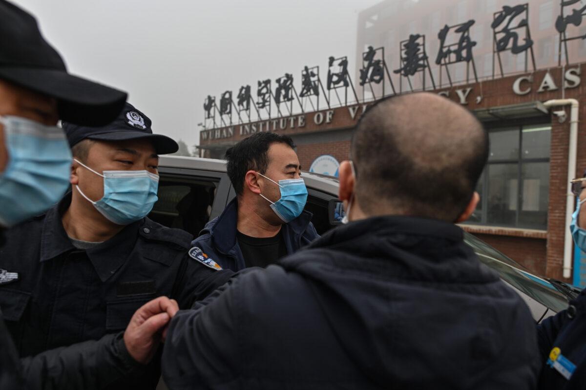 Security personnel are seen as members of the World Health Organization (WHO) team investigating the origins of COVID-19 arrive at the Wuhan Institute of Virology in Wuhan, China on Feb. 3, 2021. (Hector Retamal/AFP via Getty Images)