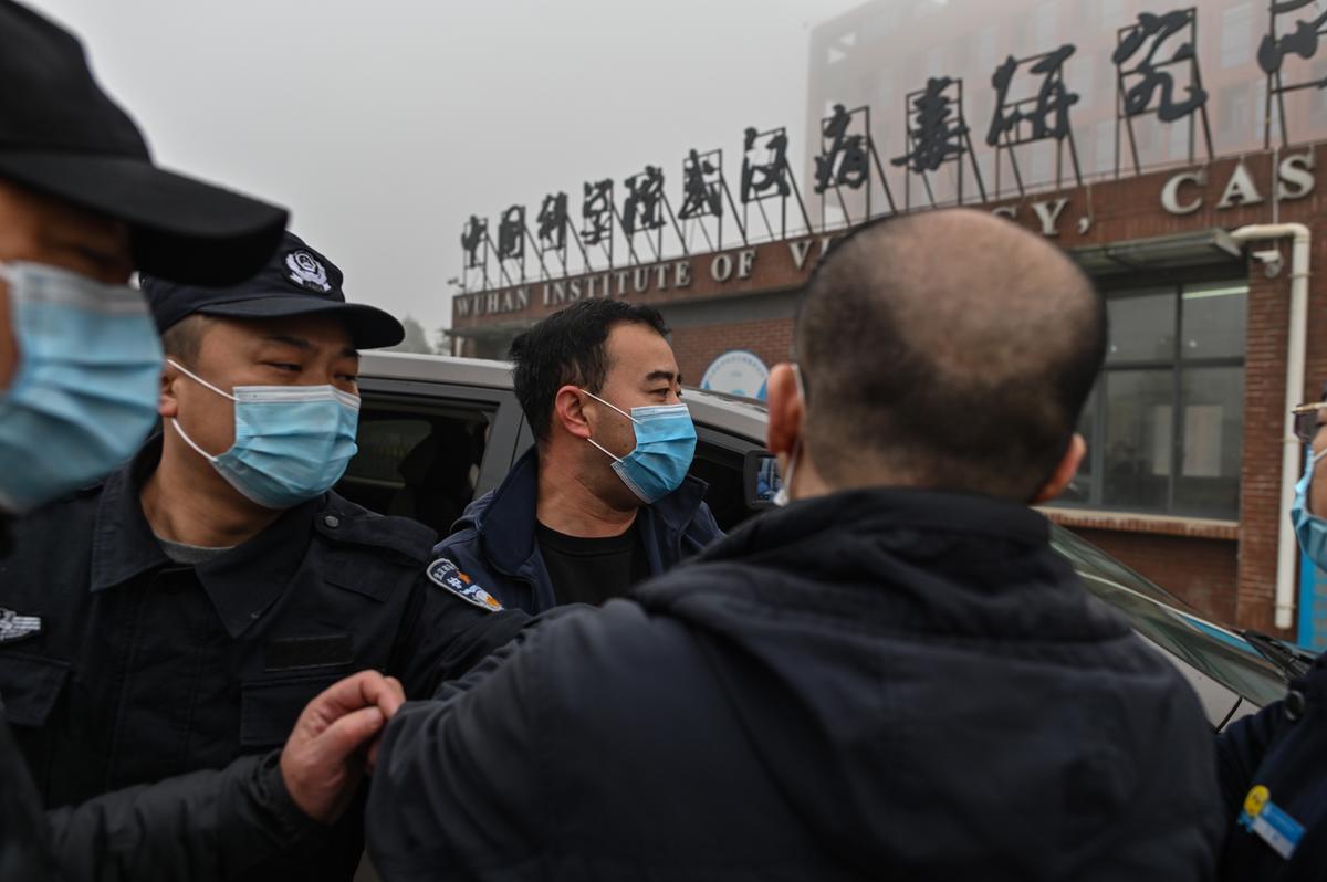 Security personnel are seen as members of the World Health Organization (WHO) team investigating the origins of the COVID-19 arrive at the Wuhan Institute of Virology in Wuhan, China on Feb. 3, 2021. (Hector Retamal/AFP via Getty Images)