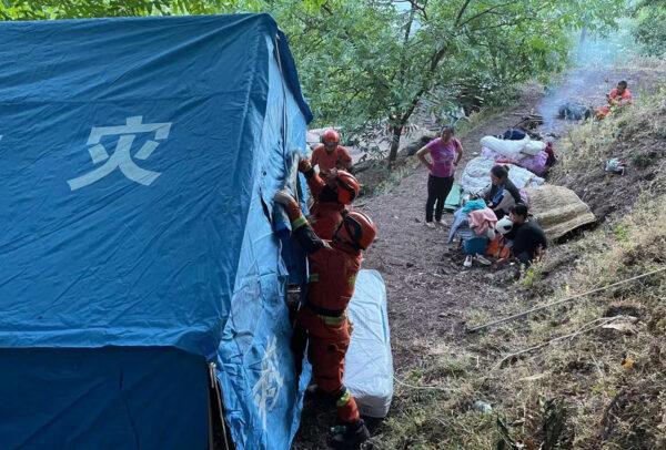 Firefighters set up temporary tents for people displaced by an overnight earthquake in Yangbi County, Dali Prefecture, in China's southwest Yunnan province on May 22, 2021. (AFP via Getty Images)