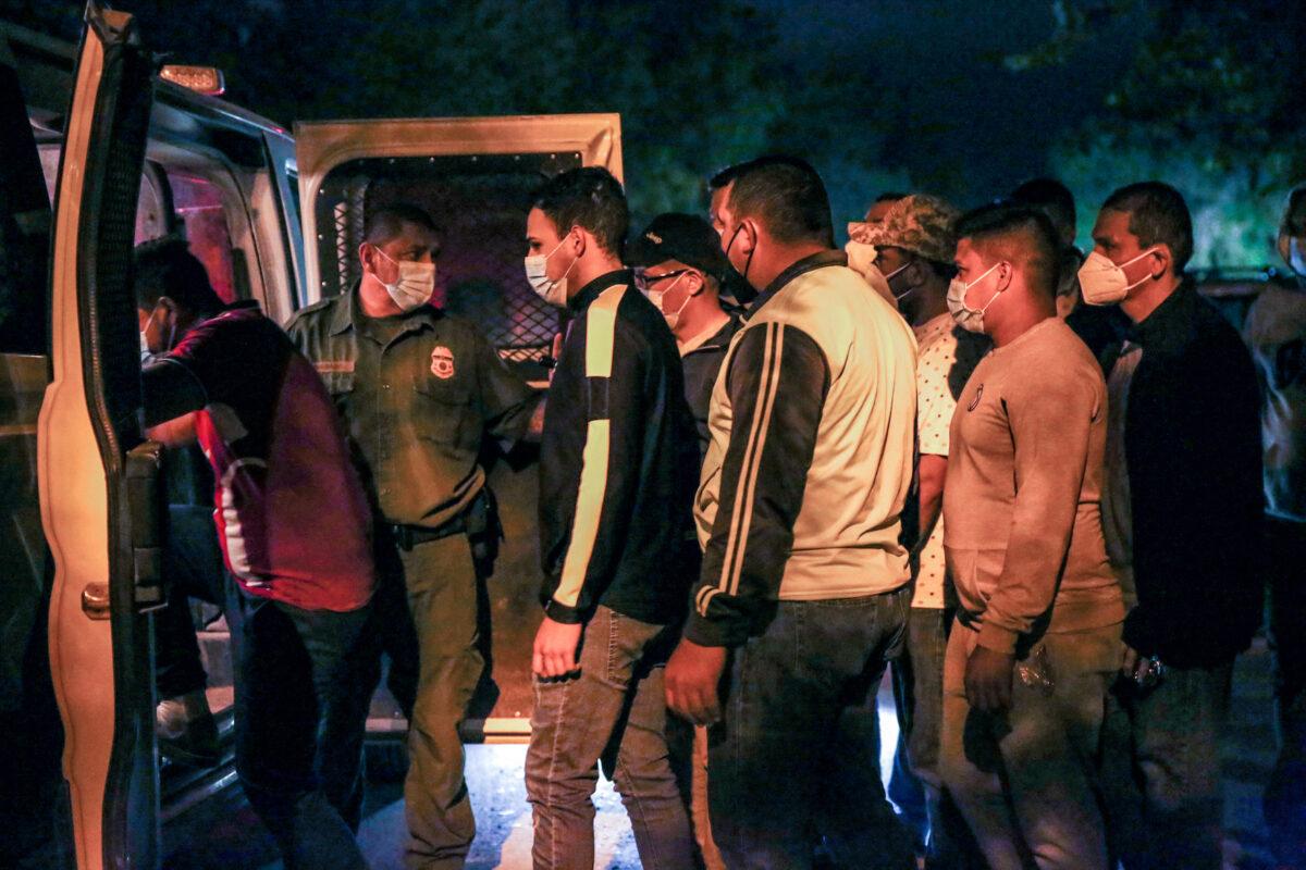 Border Patrol agents detain illegal immigrants after they cross the Rio Grande from Mexico into Del Rio, Texas, on May 23, 2021. (Charlotte Cuthbertson/The Epoch Times)
