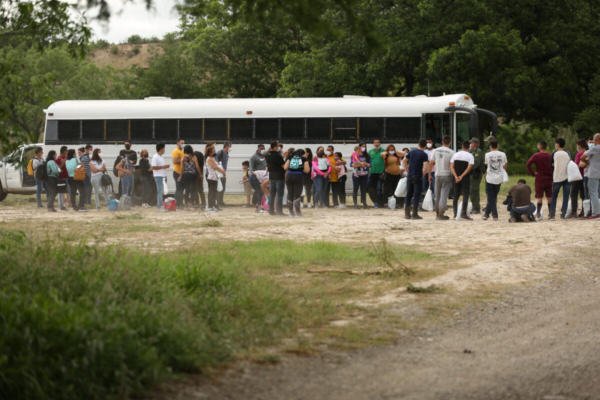 Border Patrol agents detain about 50 illegal immigrants after they cross the Rio Grande from Mexico into Del Rio, Texas, on May 24, 2021. (Charlotte Cuthbertson/The Epoch Times)