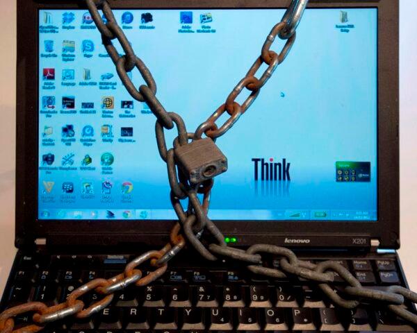 A computer wrapped in padlocked chains is seen in Montreal in a Dec. 14, 2012, photo illustration. (Ryan Remiorz/The Canadian Press)