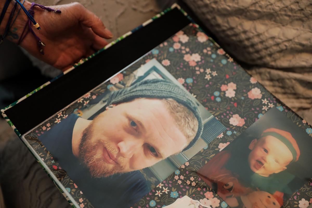  Michele Holbrook looks at photos of her son Chandler Cook, who died of an overdose, at her home in Fernandina Beach, Fla., on May 19, 2021. (Samira Bouaou/The Epoch Times)