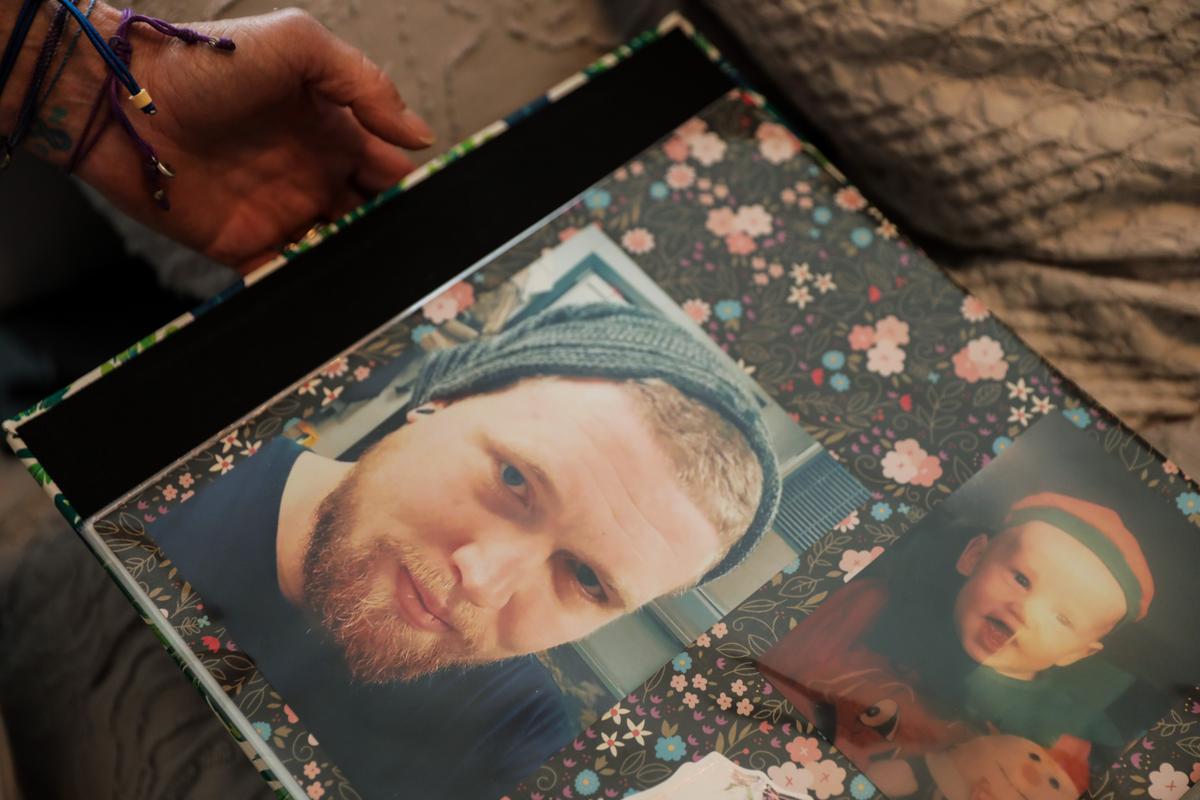 Michele Holbrook looks at photos of her son Chandler Cook, who died of an overdose, at her home in Fernandina Beach, Fla., on May 19, 2021. (Samira Bouaou/The Epoch Times)