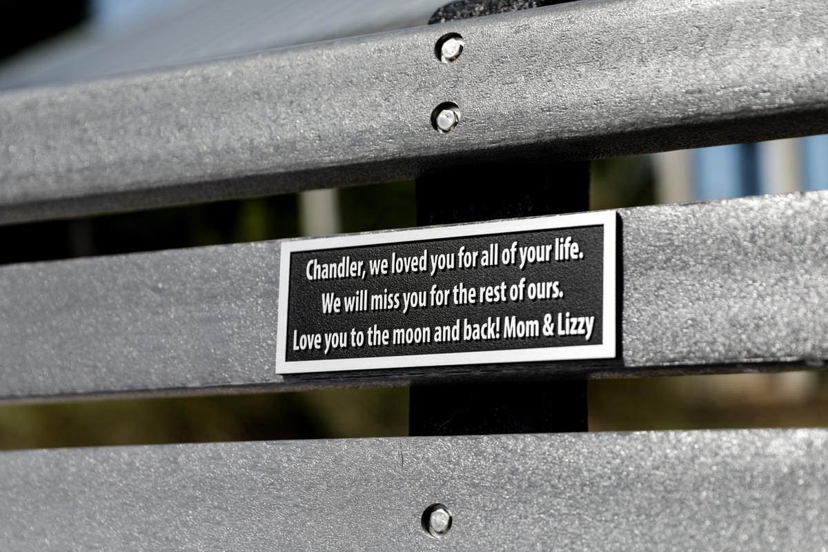 A bench in memory of Chandler Cook at a local park in Fernandina Beach, Fla., on May 19, 2021. (Samira Bouaou/The Epoch Times)