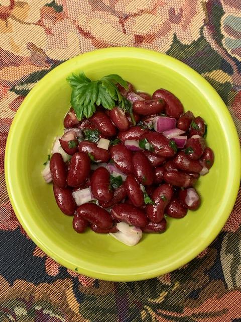 A side dish of kidney beans, chopped red onion, and chopped fresh parsley, dressed with the same simple salad dressing. (Courtesy of Valerie A. Winters)