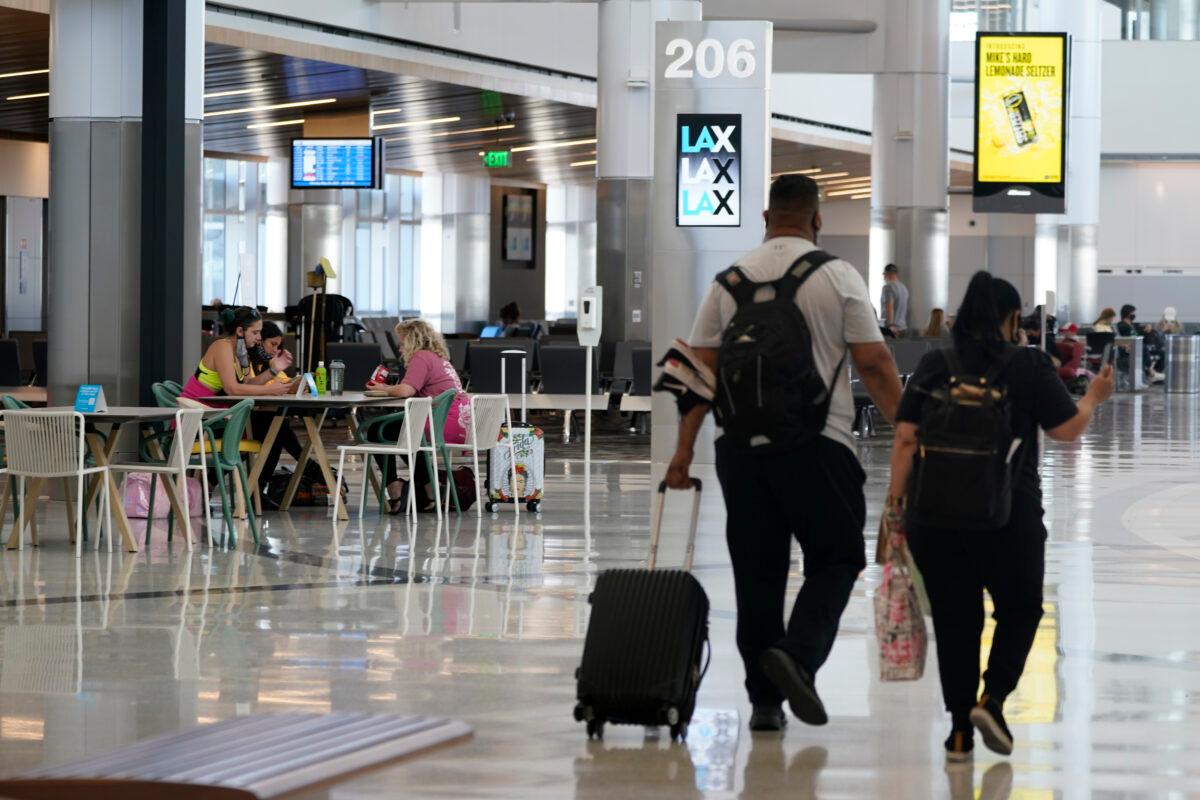 Passengers wait for their flights inside the new West Gates at Tom Bradley International Terminal at Los Angeles International Airport, on May 24, 2021. (AP Photo/Ashley Landis)