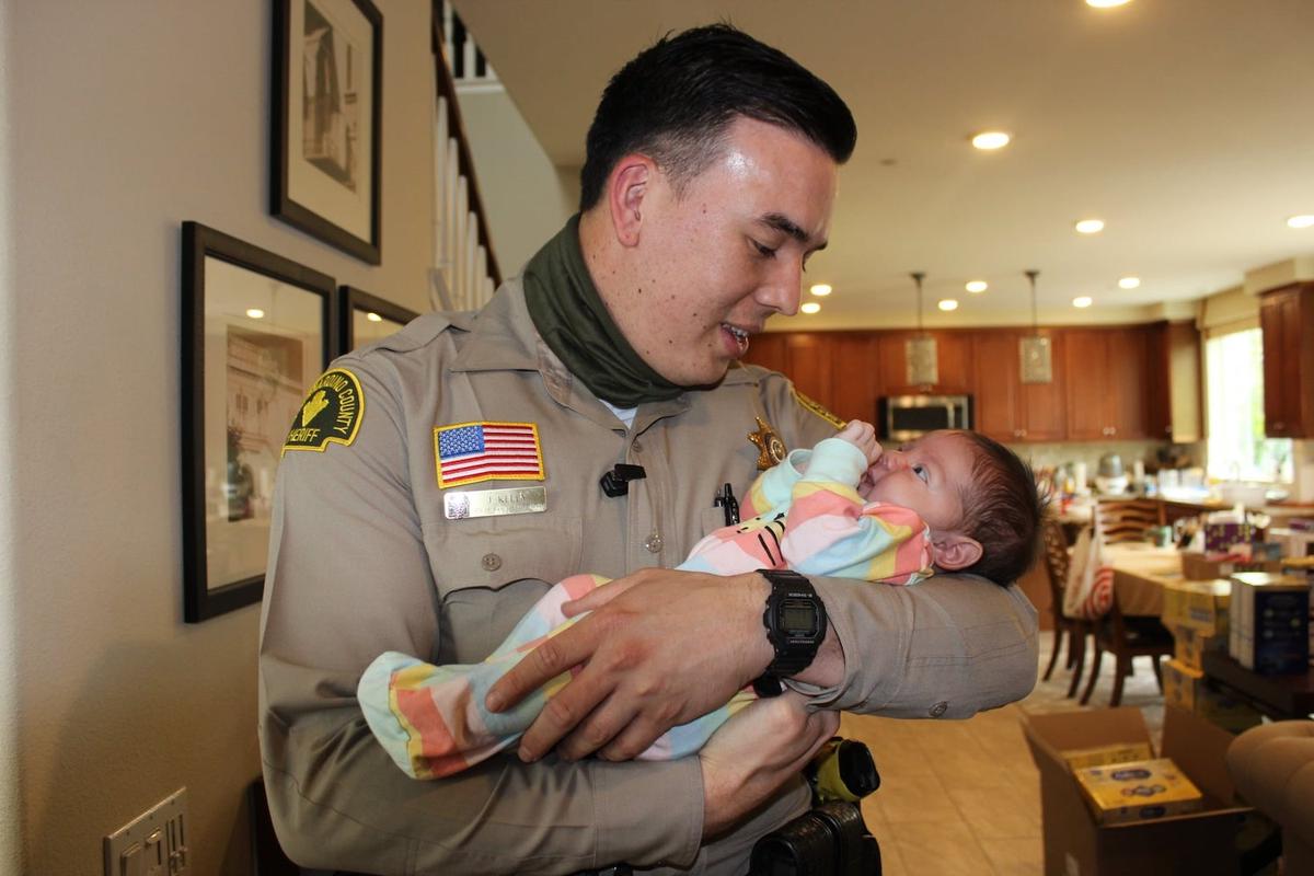 Deputy Joshua Kelly with baby Victoria. (Courtesy of <a href="https://wp.sbcounty.gov/sheriff/">San Bernardino County Sheriff's Department</a>)