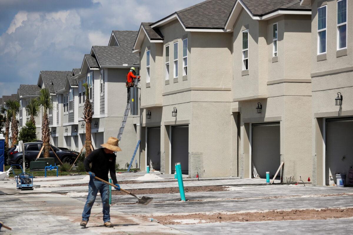 A carpenter works on building new townhomes that are still under construction while building material supplies are in high demand in Tampa, Fla., on May 5, 2021. (Octavio Jones/Reuters)