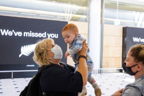 A woman hugs her grandson who she meets for the first time at Sydney International Airport as the New Zealand-Australia travel bubble opens on April 19, 2021, in Sydney, Australia. (Jenny Evans/Getty Images)