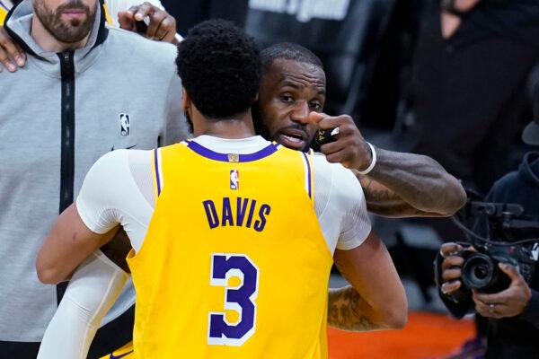 Los Angeles Lakers forward LeBron James, rear, hugs forward Anthony Davis (3) after Game 2 of the team's NBA basketball first-round playoff series against the Phoenix Suns in Phoenix, Ariz., on May 25, 2021. (Ross D. Franklin/AP Photo)