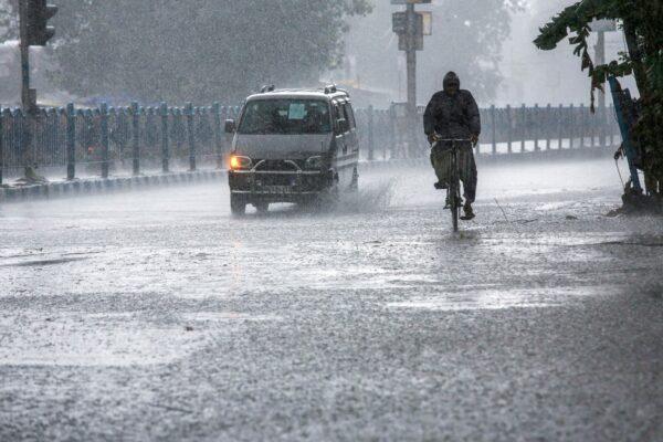 A man pedals through heavy rain under the inclement weather due to Cyclone Yaas in Kolkata, India, on May 26, 2021. (Bikas Das/AP Photo)