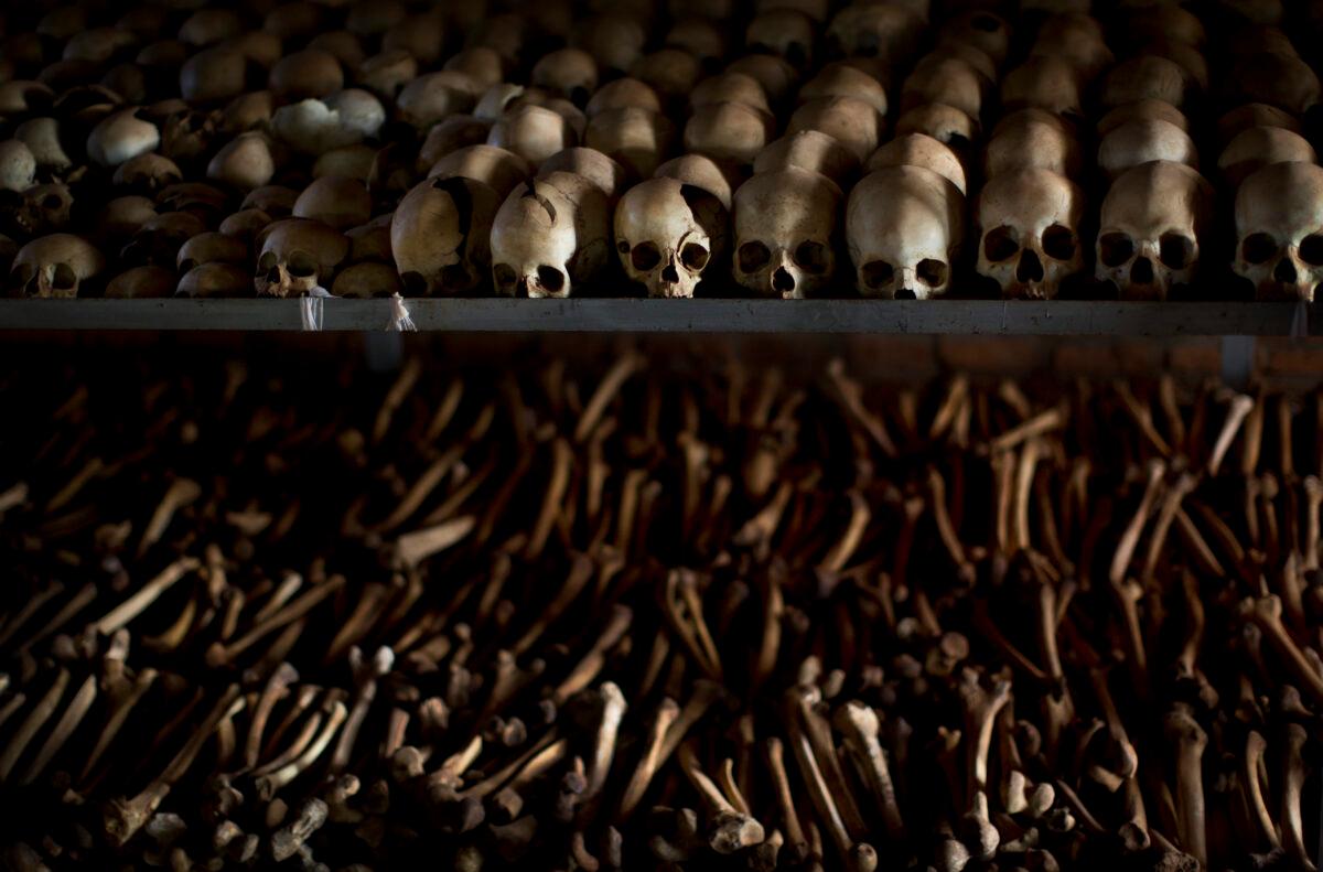 The skulls and bones are laid out on shelves in an underground vault as a memorial to the thousands who were killed in and around the Catholic church during the 1994 genocide in Nyamata, Rwanda, on April 4, 2014. (Ben Curtis/AP Photo)