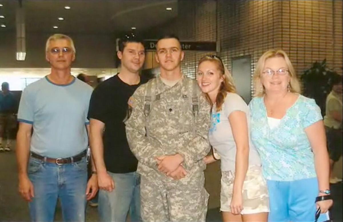 A photo with Deanna (Far Right), Joel in uniform (C), her husband (Far Left), and other family members. (Courtesy of <a href="https://www.facebook.com/DeeHouse">Deanna House</a>)