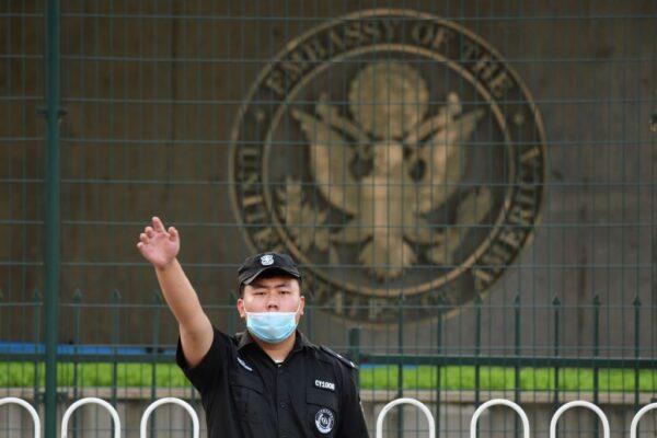 A Chinese security guard gestures outside the U.S. embassy in Beijing on Sept. 12, 2020. (Greg Baker/AFP via Getty Images)