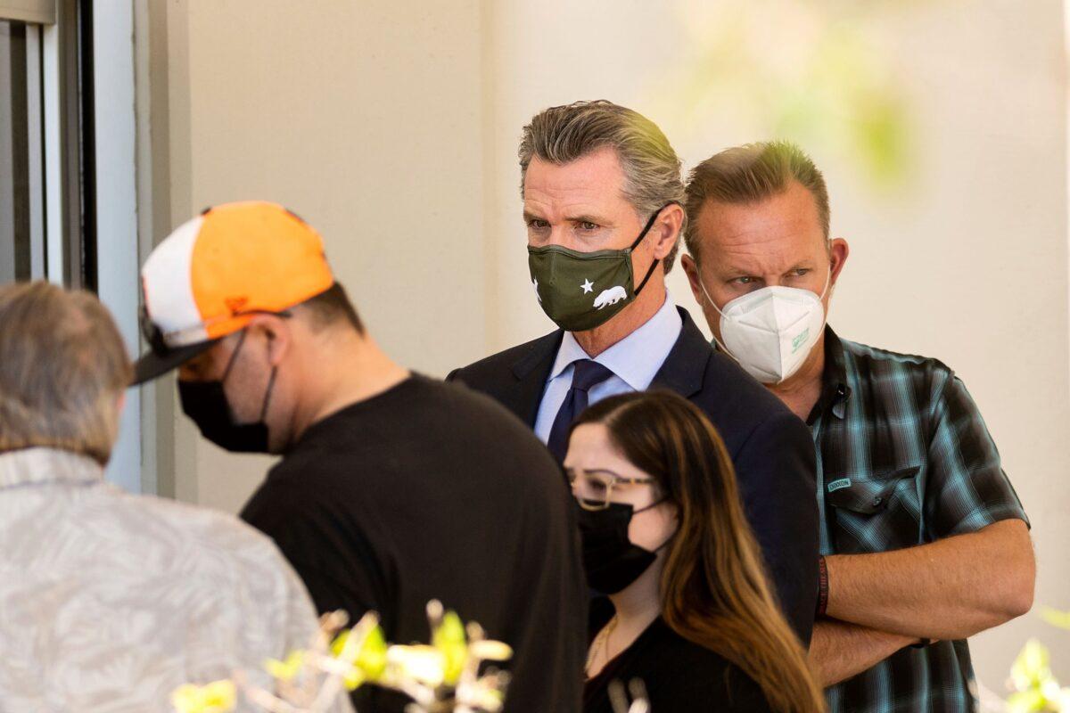 California Gov. Gavin Newsom leaves a staging area for Santa Clara Valley Transportation Authority (VTA) workers, family members and officials following a shooting at one of the agency's rail yards in San Jose, Calif., on May 26, 2021. (Noah Berger/AP Photo)