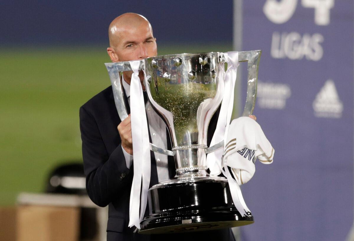 Real Madrid's head coach Zinedine Zidane holds the trophy after winning the Spanish La Liga 2019-2020 in Madrid, Spain, on July 16, 2020. (Bernat Armangue/AP Photo)