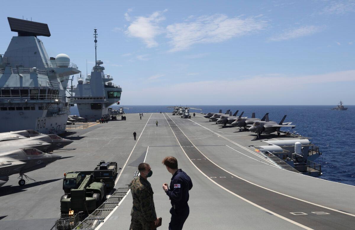 Military personnel participate in the NATO Steadfast Defender 2021 exercise on the deck of the aircraft carrier HMS Queen Elizabeth off the coast of Portugal, on May 27, 2021. (Ana Brigida /AP Photo)