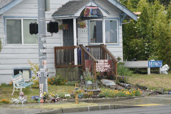 Signs and a cross are displayed on May 27, 2021, at the "Manny's Garden" memorial that has been established at the intersection in Tacoma, Wash., south of Seattle, where Manuel "Manny" Ellis died on March 3, 2020. (Ted S. Warren/AP Photo)