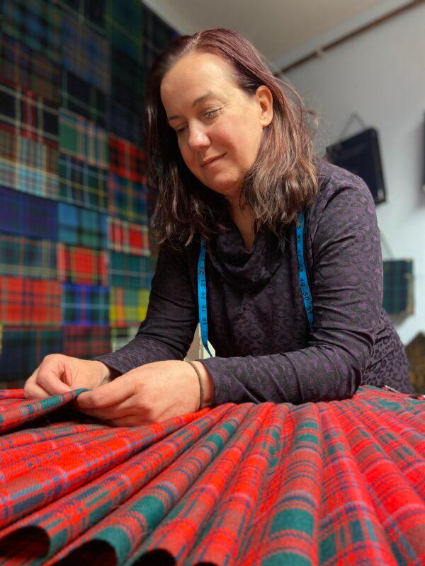 Kilt making is newly classified as an "endangered craft" in the UK. Kilt maker Amanda Moffet hand-sews a kilt at The Kiltmakery in Edinburgh, Scotland. (The Kiltmakery & ScotClans)