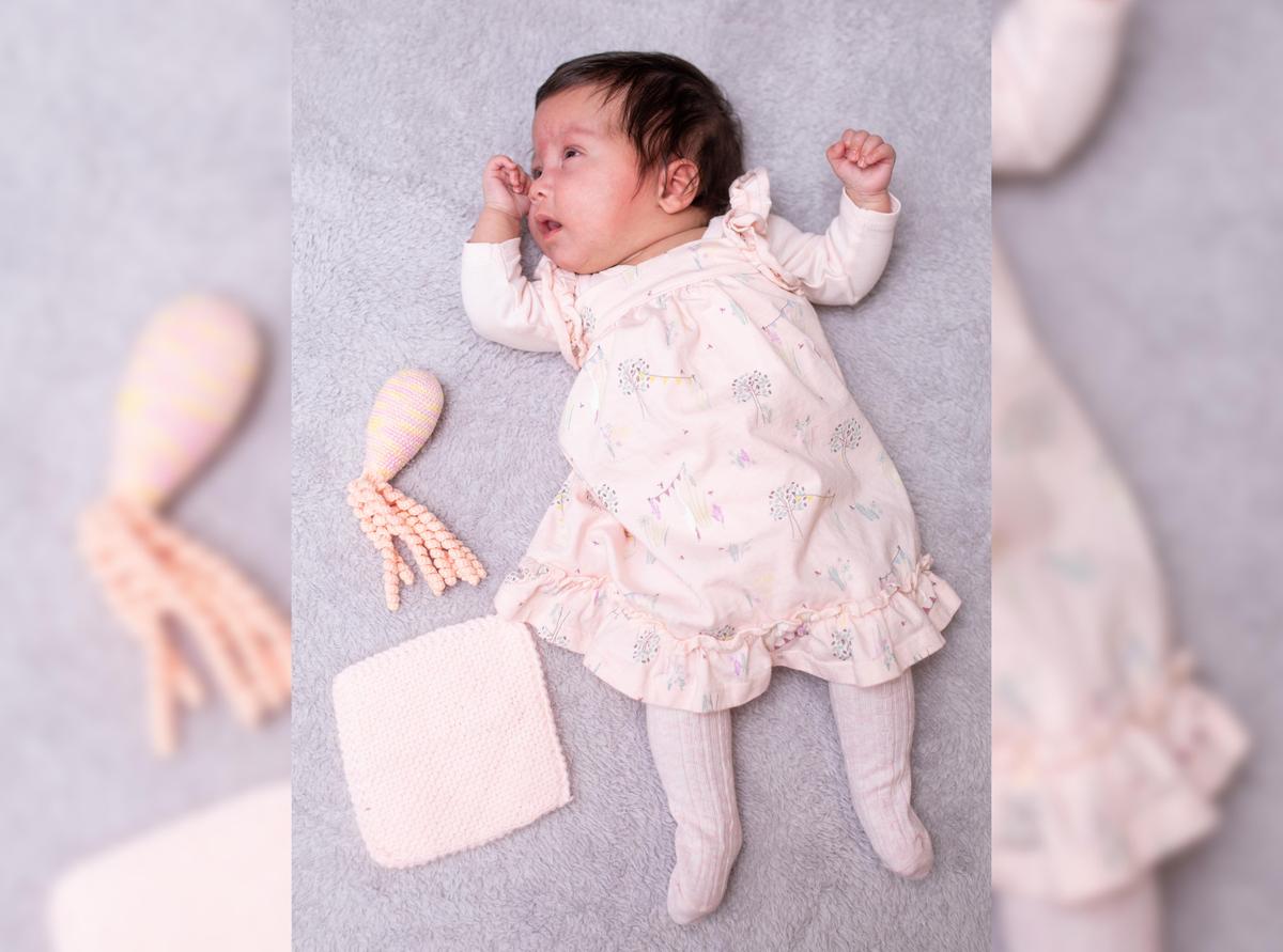 Baby Arabella next to her toy octopus and pink blankie after leaving the hospital. (Courtesy of Caters News)