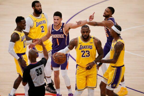 Phoenix Suns guard Devin Booker (1) argues with a referee after fouling Los Angeles Lakers forward LeBron James (23) during the first half in Game 3 of an NBA basketball first-round playoff series in Los Angeles, Calif., on May 27, 2021. (Marcio Jose Sanchez/AP Photo)