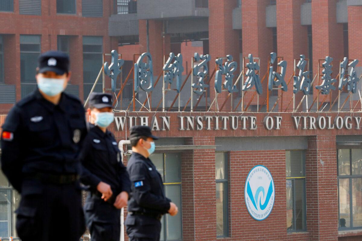 Security personnel keep watch outside the Wuhan Institute of Virology during the visit by the World Health Organization (WHO) team tasked with investigating the origins of the coronavirus disease (COVID-19), in Wuhan, Hubei Province, China, on Feb. 3, 2021. (Thomas Peter/Reuters)