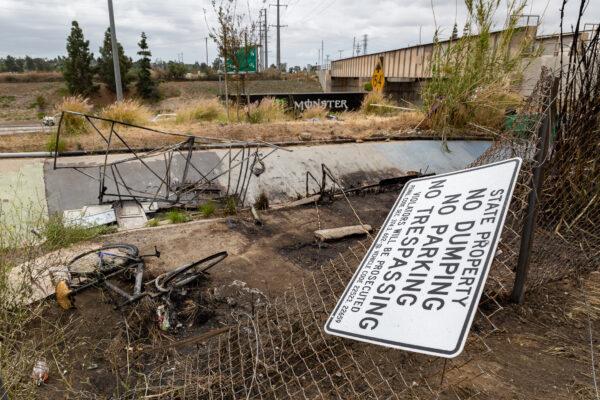 Burned items are found along the 91 Freeway near the area where a homeless man died after starting a fire, in Anaheim, Calif., on April 21, 2021. (John Fredricks/The Epoch Times)