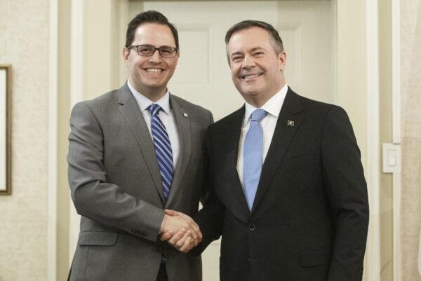 Alberta Premier Jason Kenney (R) shakes hands with Minister of Advanced Education Demetrios Nicolaides after Kenney and members of his cabinet were sworn into office in Edmonton on April 30, 2019. (Jason Franson/The Canadian Press)