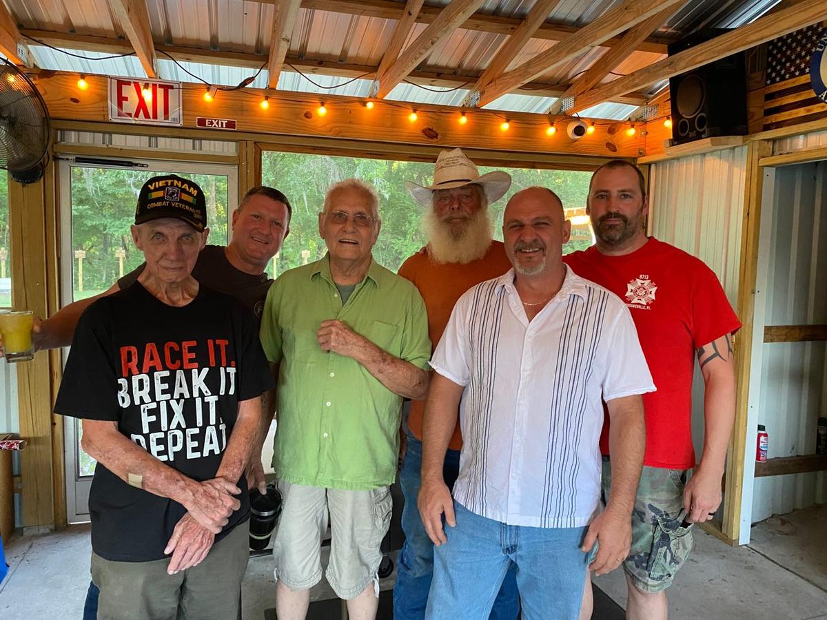Ron McCombs, Billy Butts, Robert Romance, J.O. Batten, Tim Zarbo, and Morgan Schmitz at the Brooksville Eight monument at VFW Post 8713 in Brooksville, Florida. (Patricia Tolson/The Epoch Times)