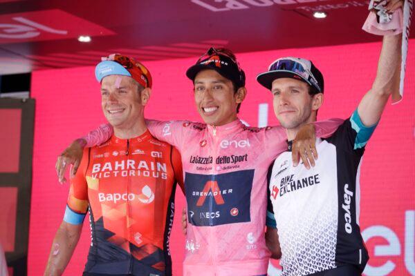 Colombia's Egan Bernal is flanked by runner-up Italy's Damiano Caruso, and third-placed Britain's Simon Yates (R) as he celebrates on podium after completing the final stage to win the Giro d'Italia cycling race, in Milan, Italy, on May 30, 2021. (Luca Bruno/AP Photo)