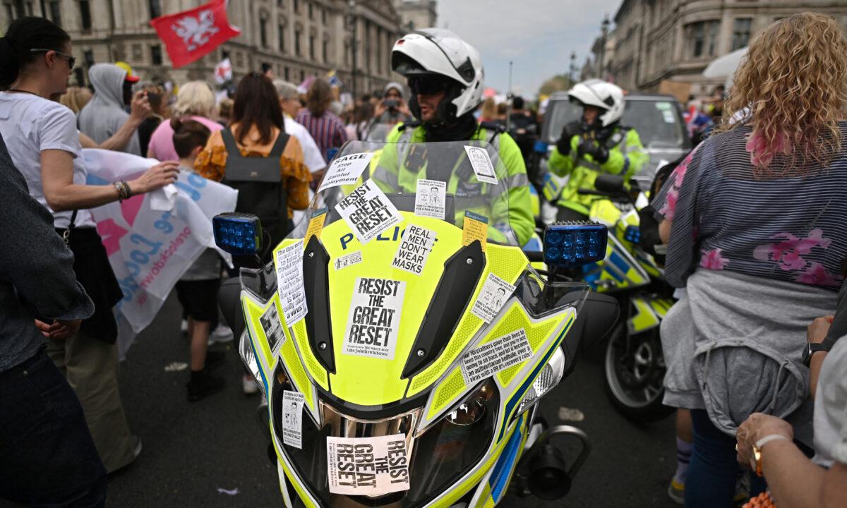 Police motorcyclists make their way through protesters marching during a 'Unite For Freedom' rally against CCP virus vaccine passport and government lockdown restrictions, in central London on May 29, 2021. (Ben Stansall/AFP via Getty Images)