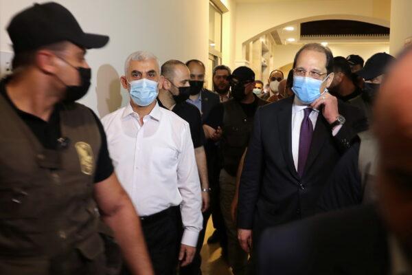Palestinian Hamas Gaza Chief Yahya Sinwar and Head of the Egyptian general intelligence Abbas Kamel (R) walk as they meet in Gaza, on May 31, 2021. (Mohammed Salem/Reuters)