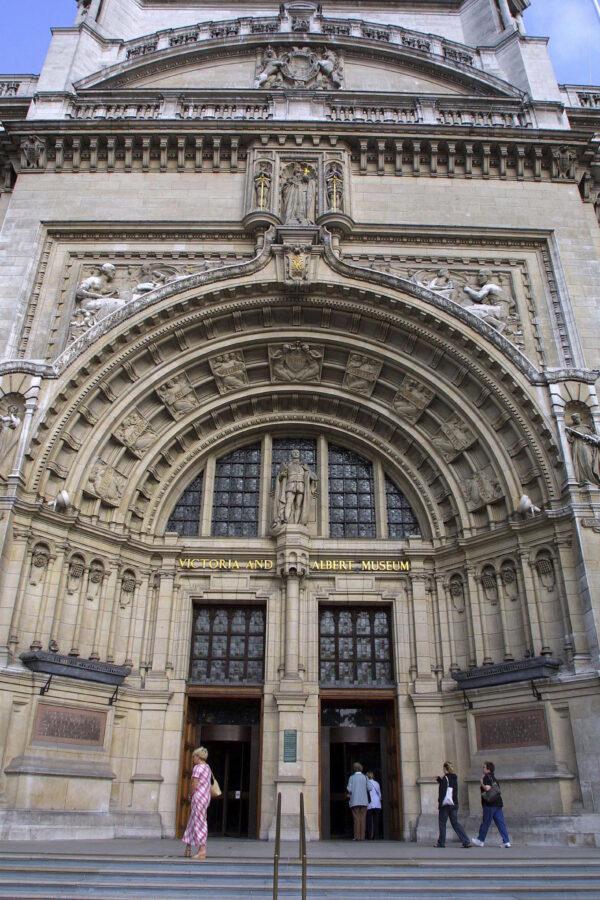 The Romanesque-style main entrance of the Victoria and Albert Museum, in London. A statue of Prince Albert is in the center of the two doors, and a statue of his wife, Queen Victoria, is above the arch. (Victoria and Albert Museum, London)