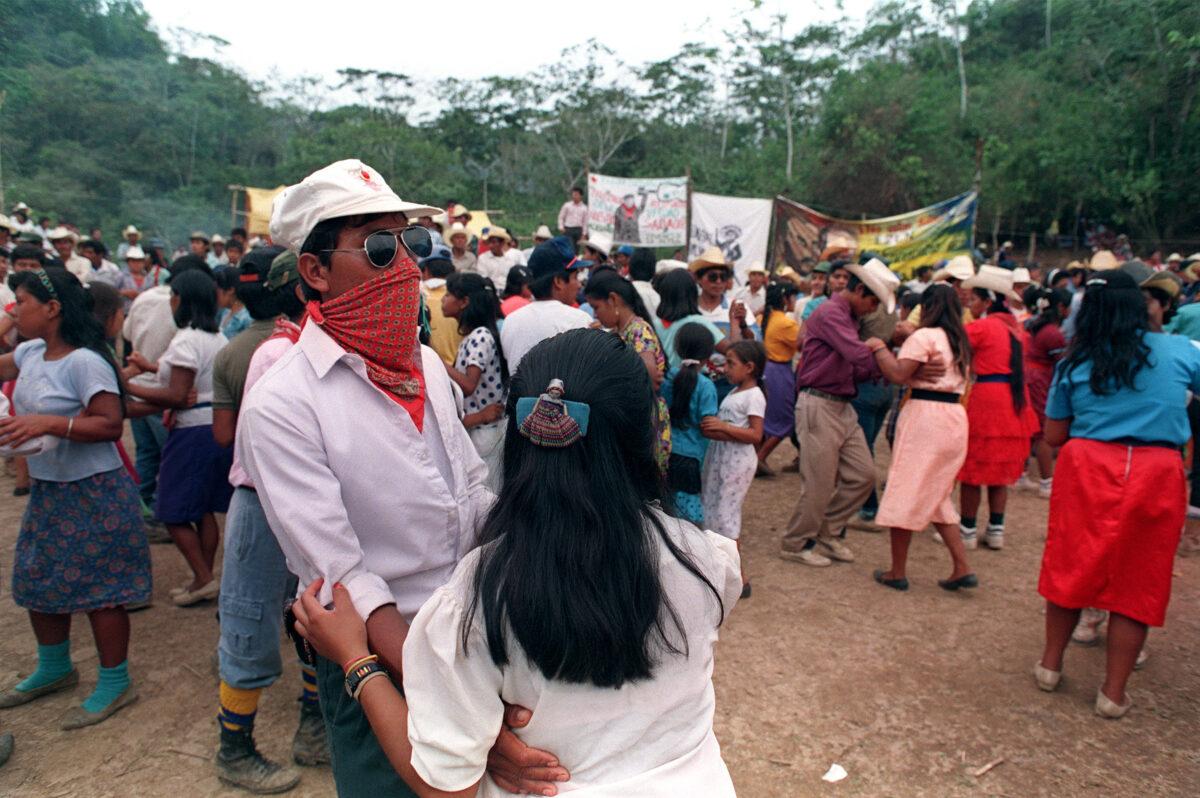 Guerrilleros of the Zapatista Army of National Liberation dance for celebrating the nomination of Party of the Democratic Revolution's candidate Cuauhtémoc Cárdenas Solórzano (not pictured) for general elections, in a camp in Chiapas, Mexico, on March 16, 1994. (Omar Torres/AFP via Getty Images)